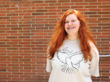 girls standing and smiling in bird shirt